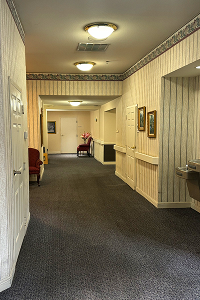 Hallway with patterned wallpaper and seating area