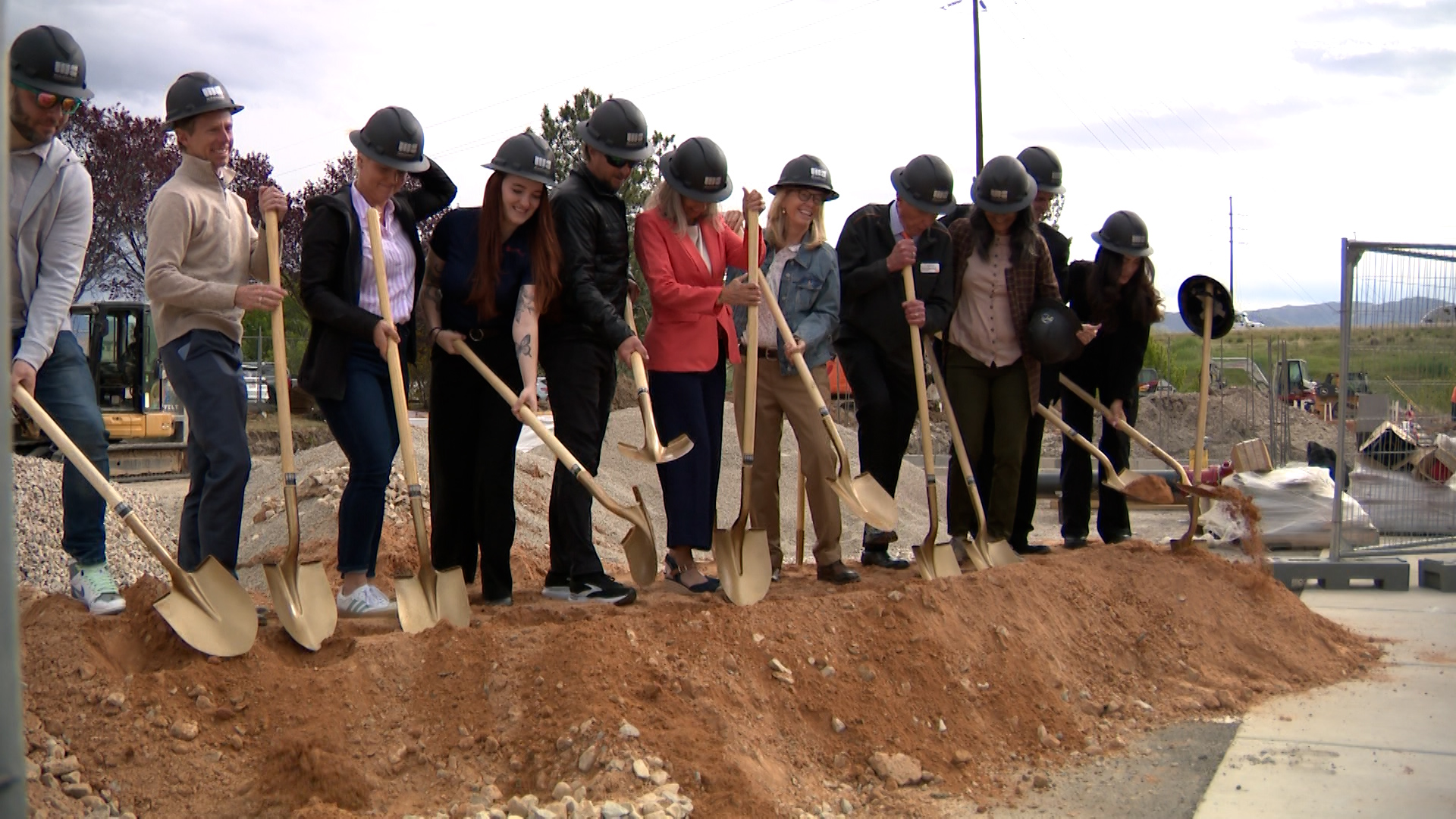 Group of people participating in a groundbreaking ceremony.