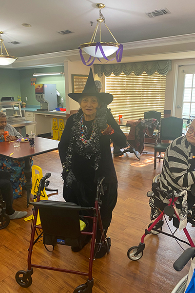 Resident dressed as a witch during a celebration.