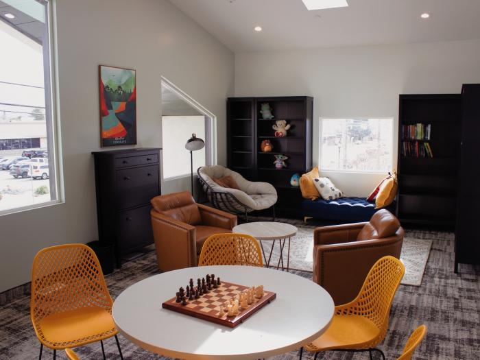 Cozy common area with seating and a chessboard.