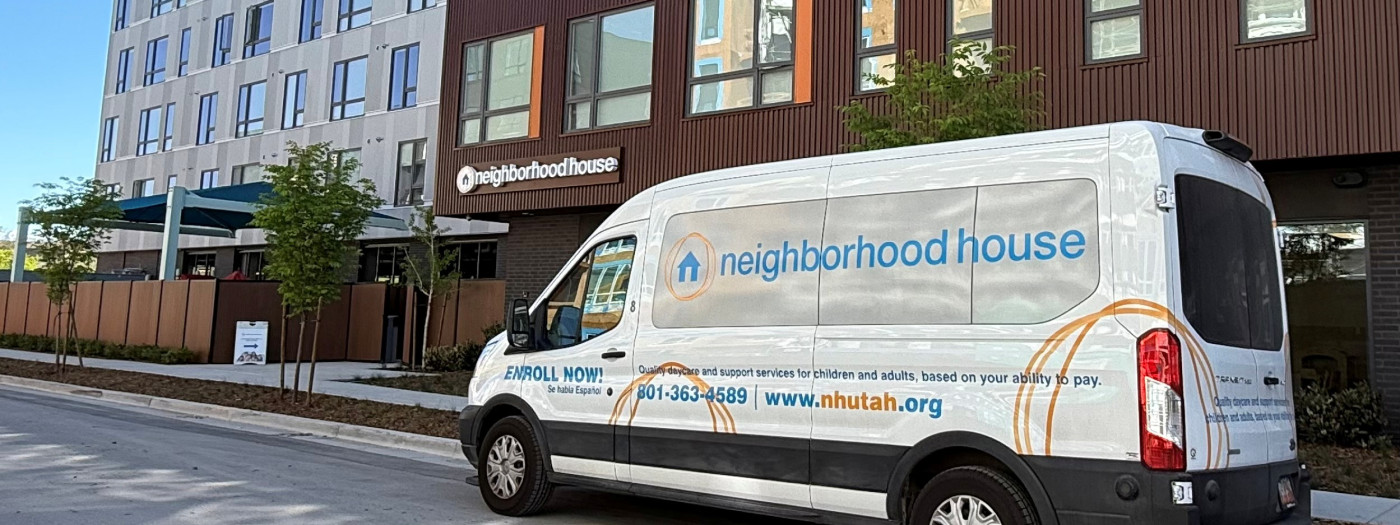 Facility van parked outside the Neighborhood House building.