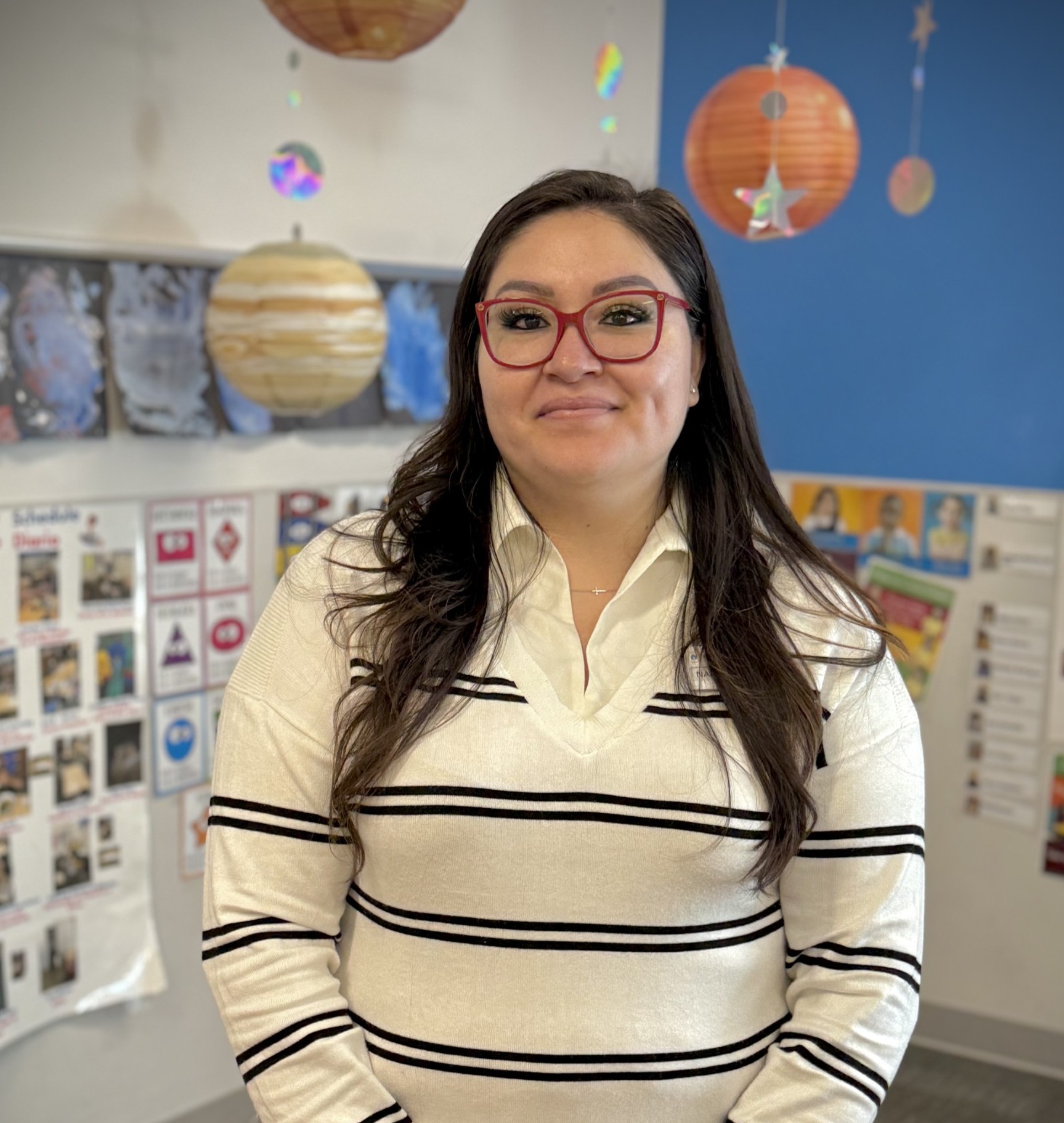 Staff member in a colorful facility setting.