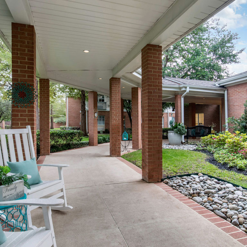 Welcoming outdoor pathway with seating and gardens.