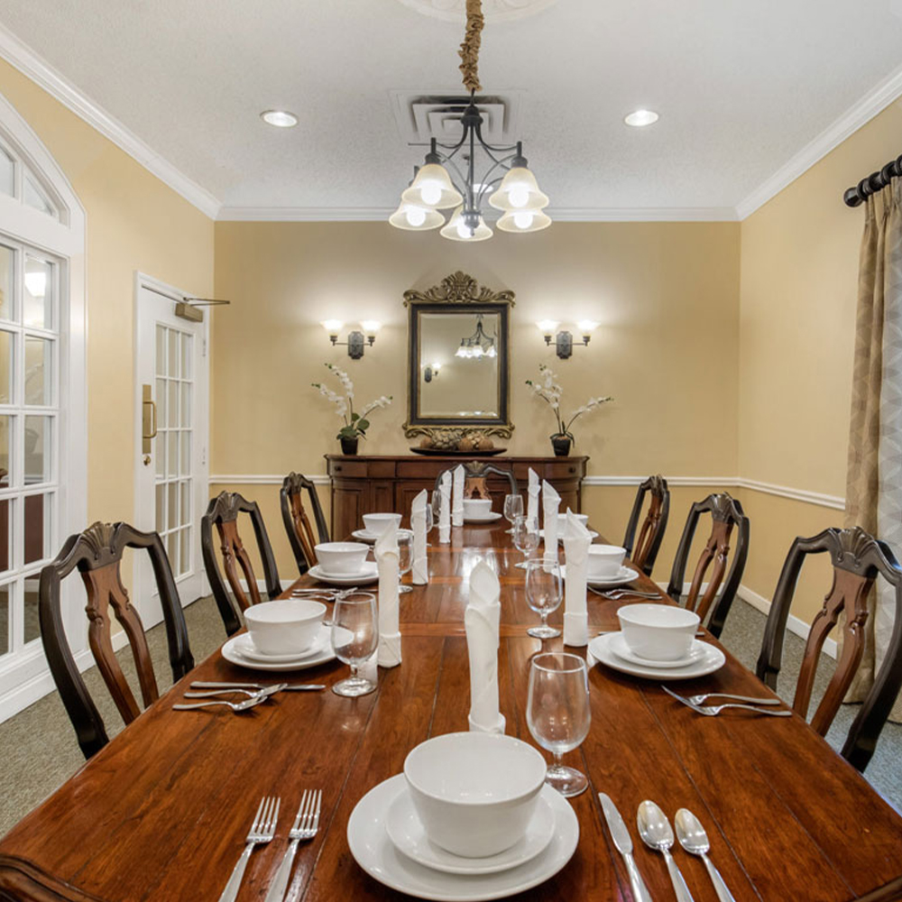 Elegant dining room setup with a long wooden table.