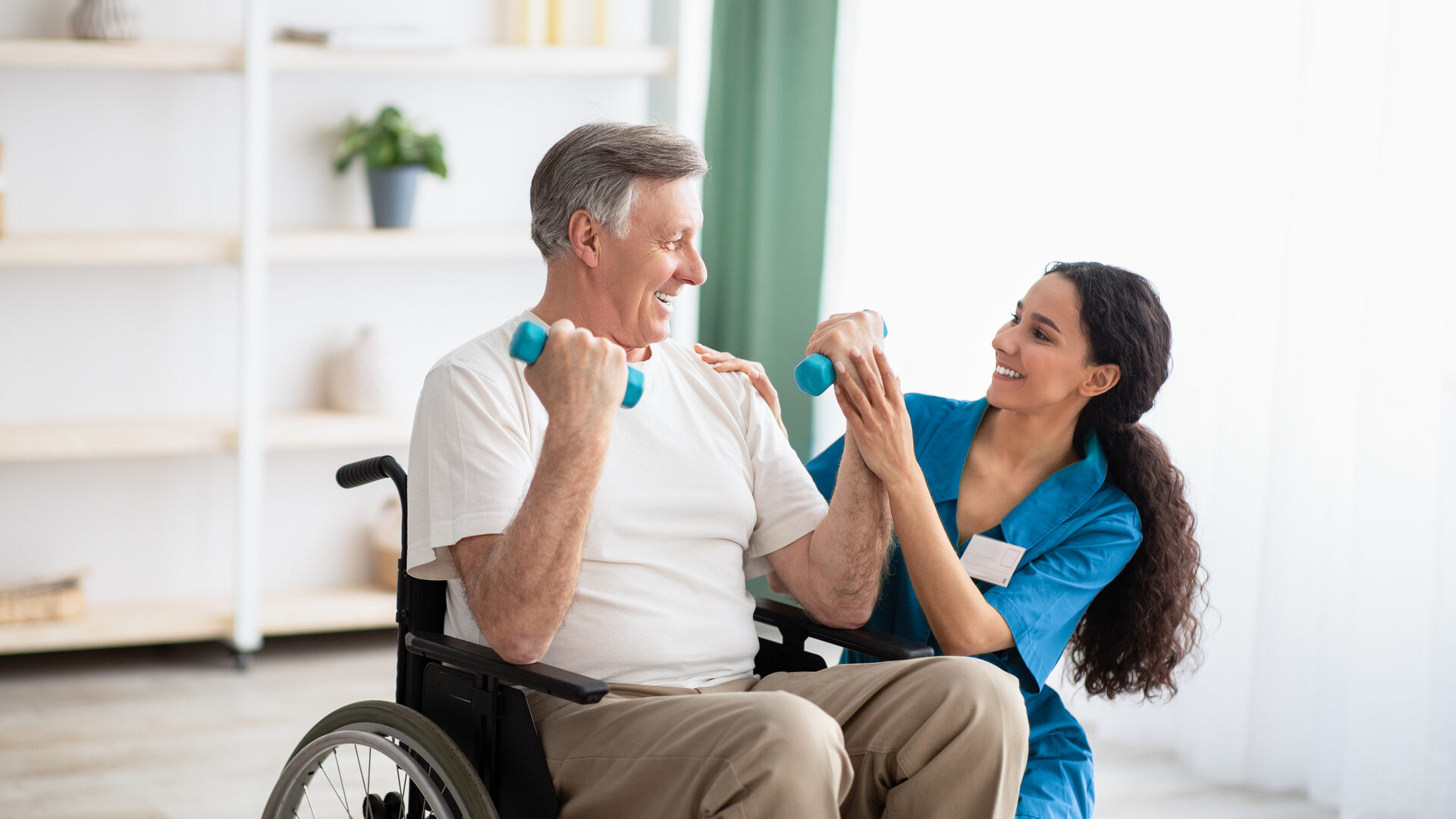 A senior exercising with a staff member