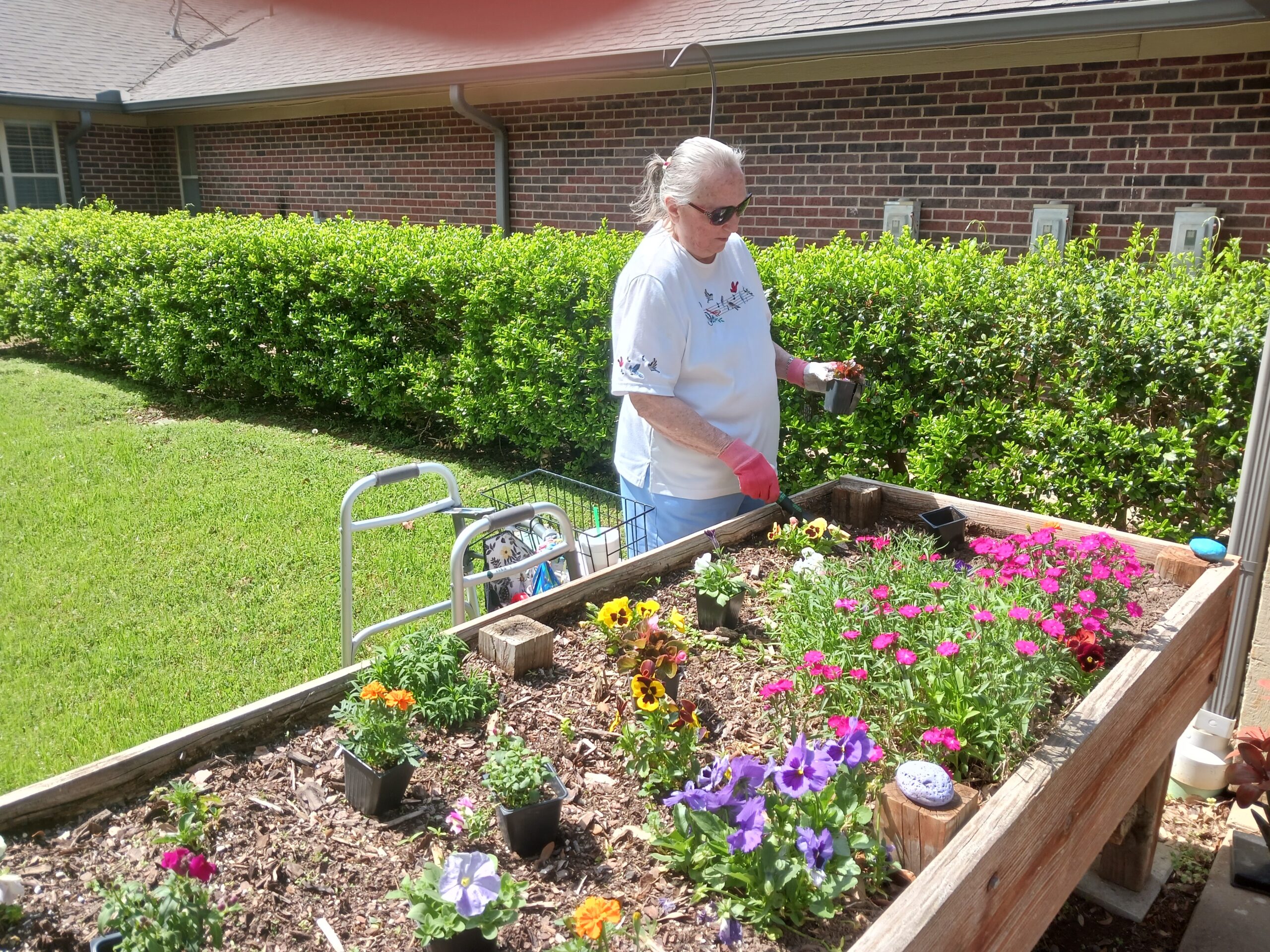 Resident tending to a colorful flower garden.