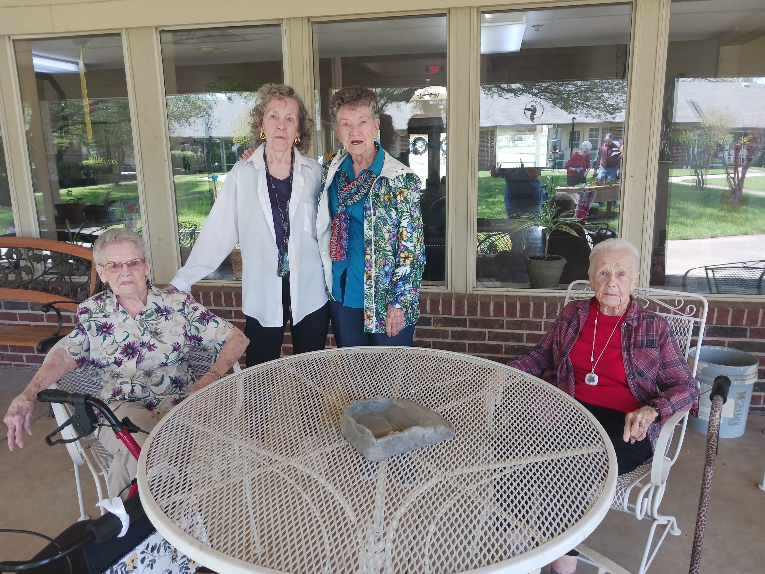 Four residents enjoying time outside together.