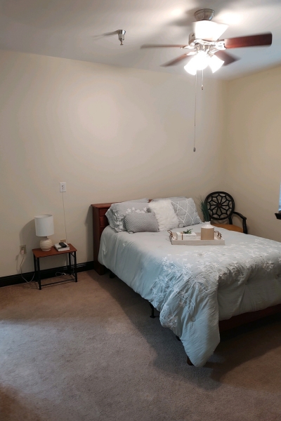 Cozy bedroom with a bed and nightstand.