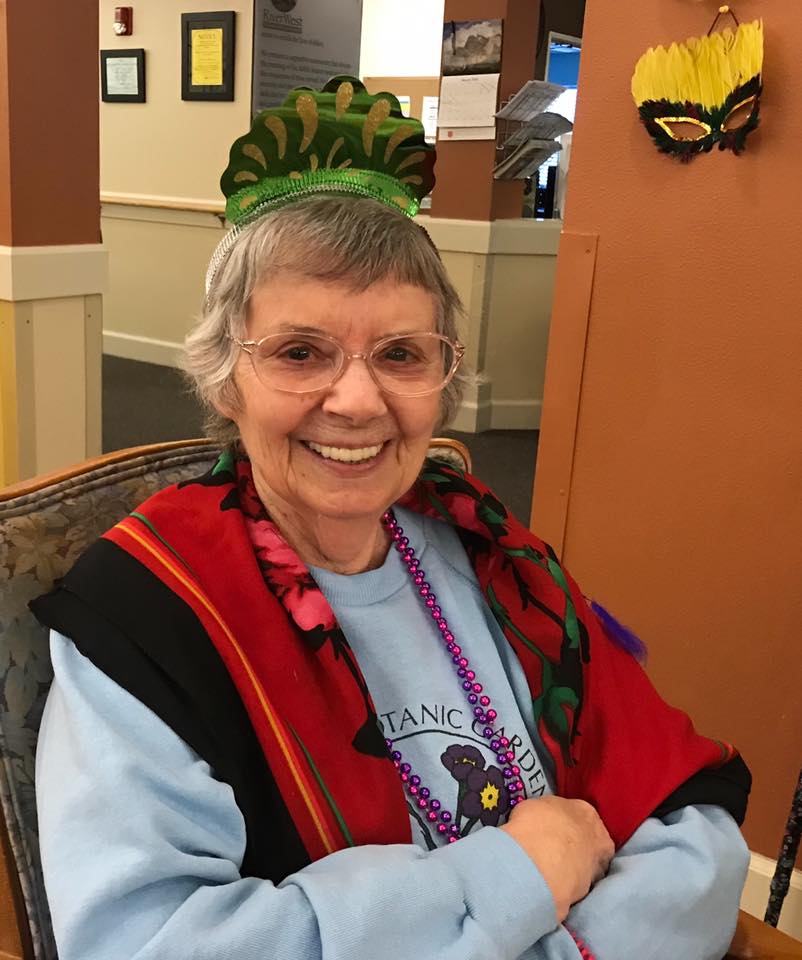 Smiling resident in festive attire.