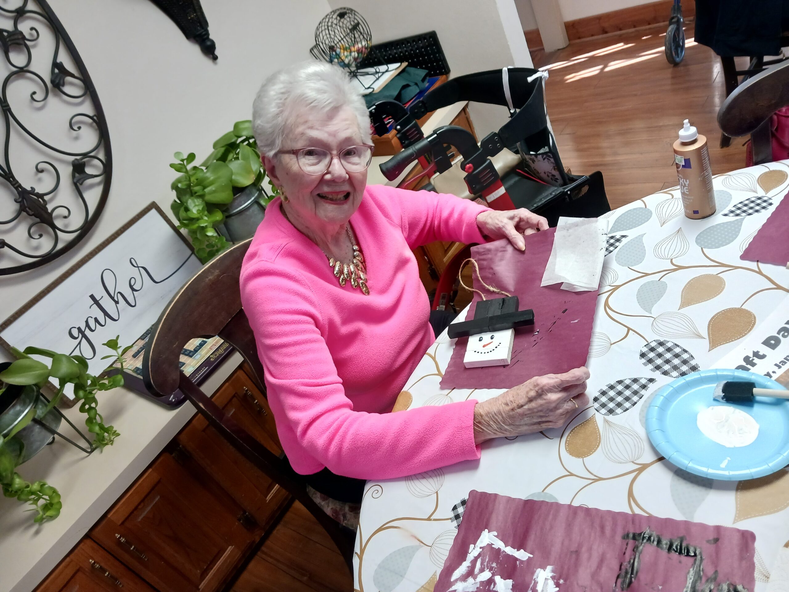 Senior resident engaged in an arts and crafts activity.