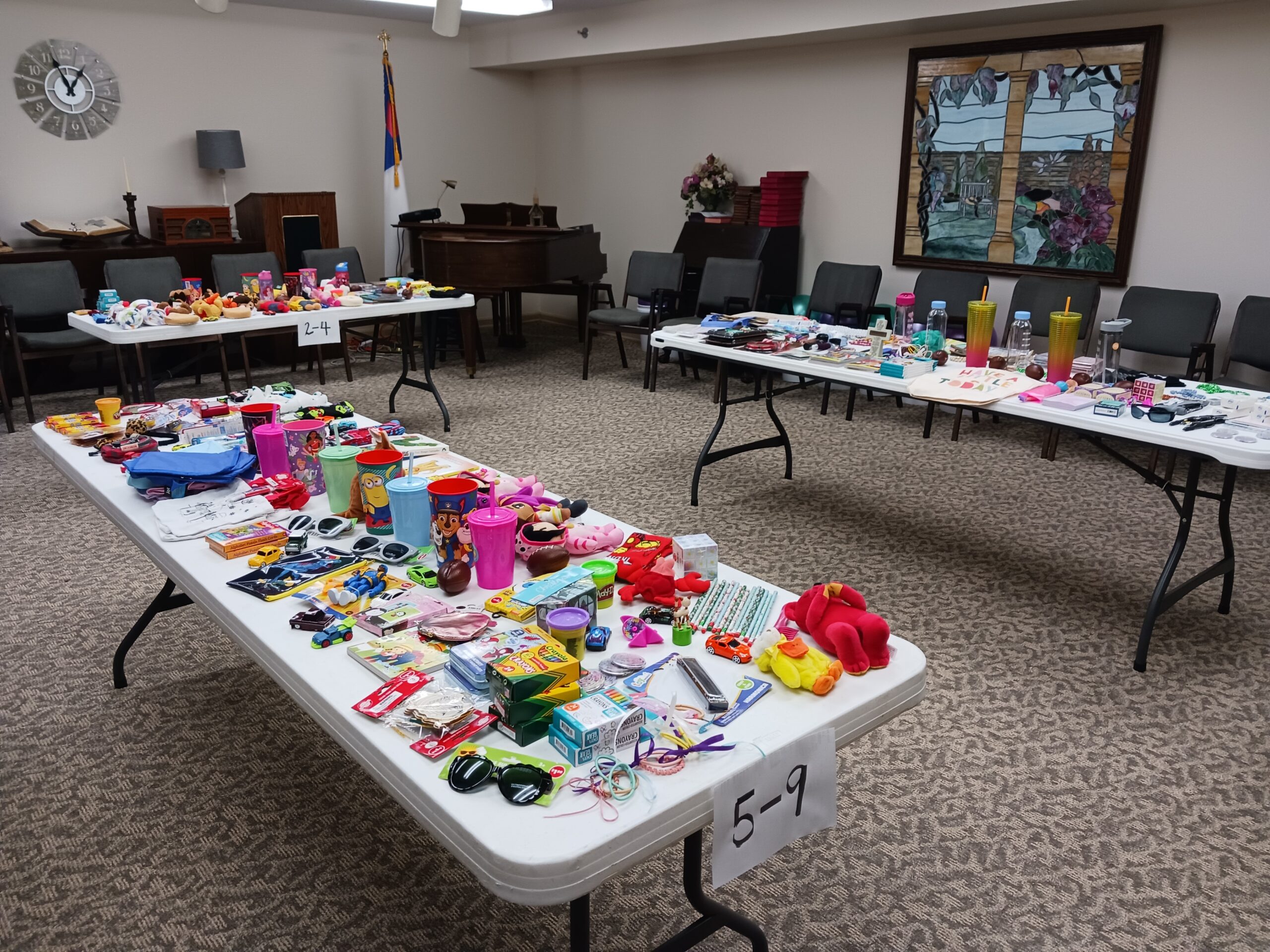 Tables filled with various items for a community event