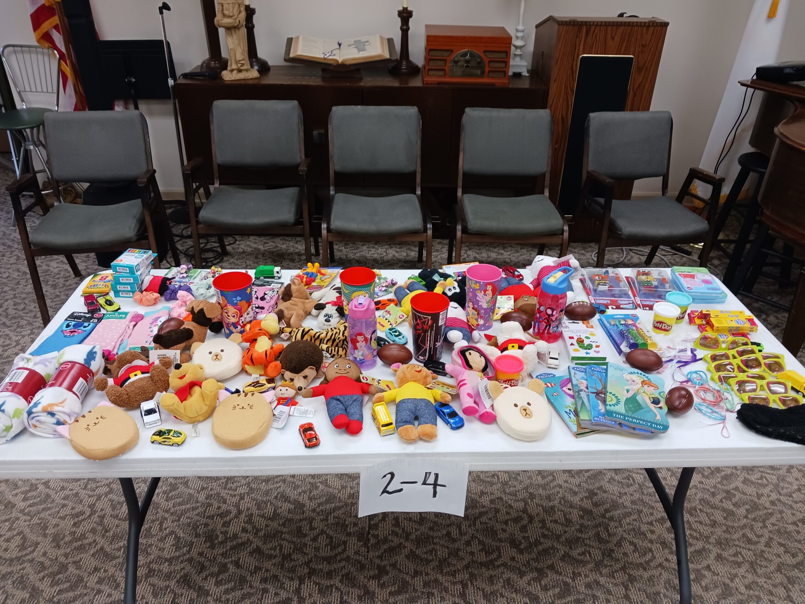 Table with various toys and items arranged creatively.