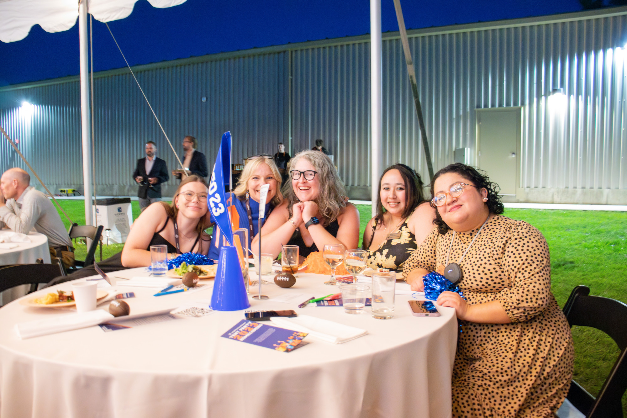 Group of friends enjoying a celebration at an outdoor event.