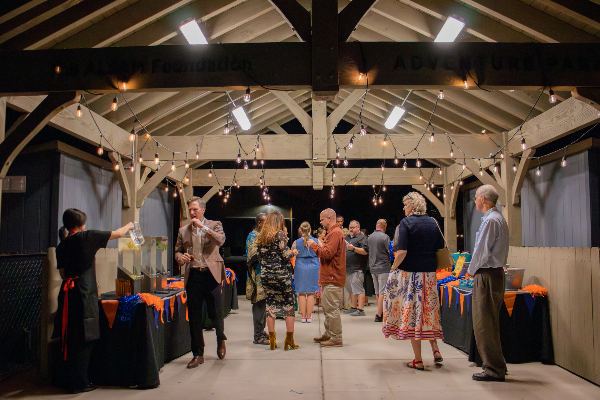 People mingling at a decorated outdoor event.