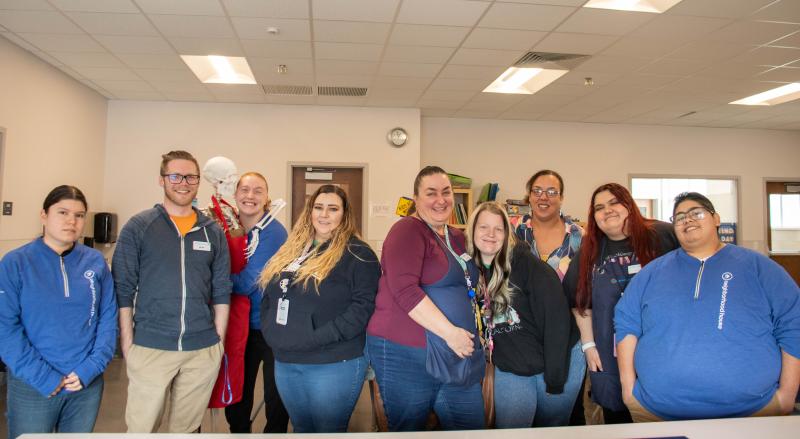 Staff and residents posing together in a common area.