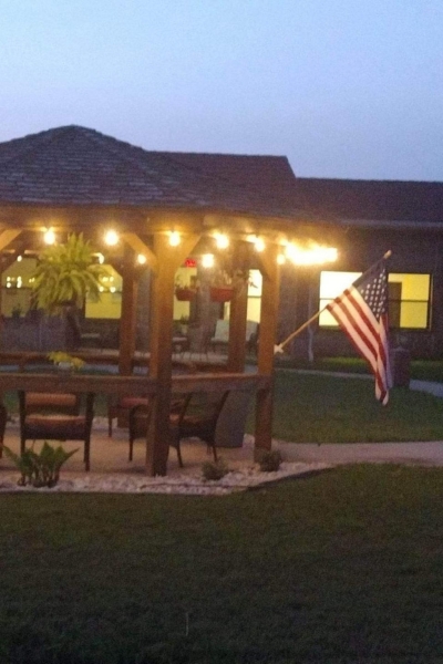 Outdoor seating area with American flag and lights