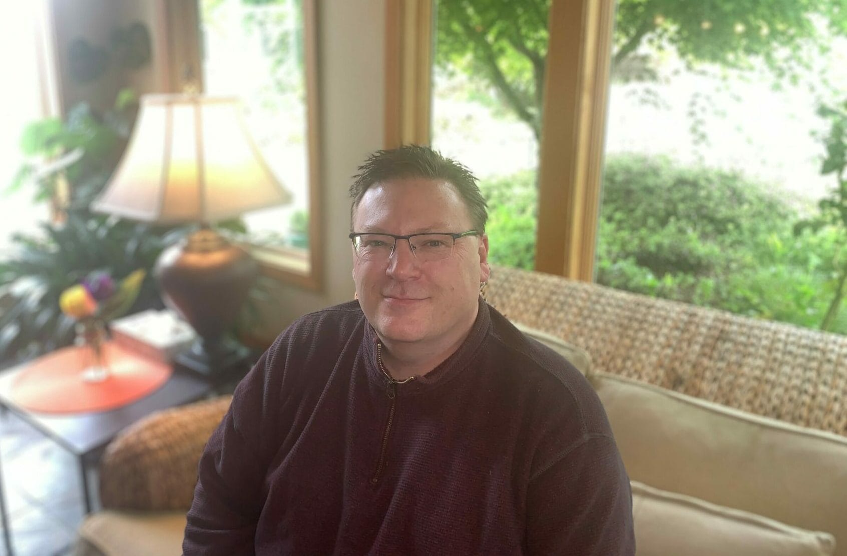 Resident smiling in a cozy living room