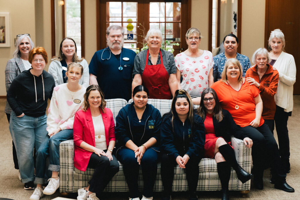 Staff and residents smiling in a common area