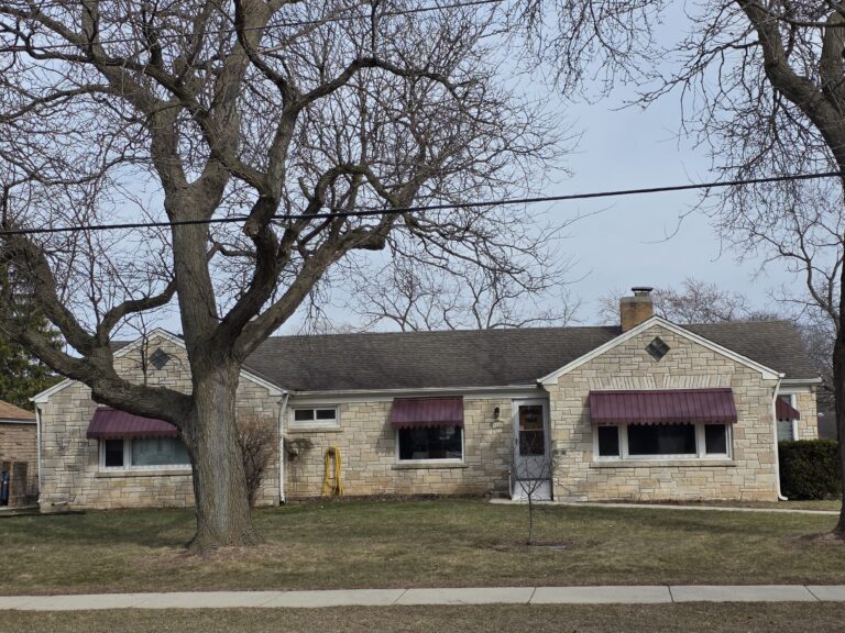 Exterior view of a single-story stone building.