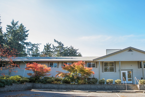 Exterior view of the facility with trees and landscaping.