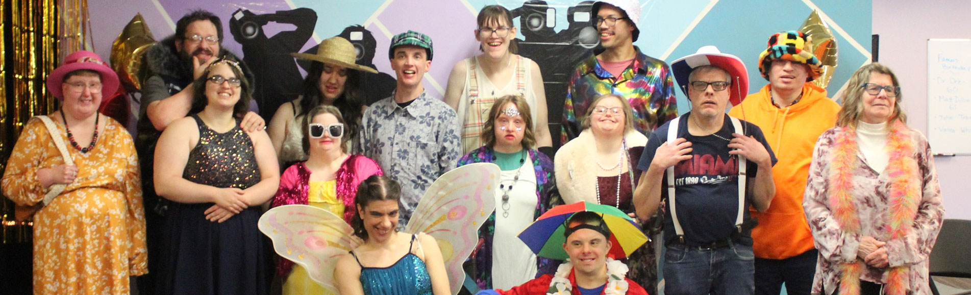 Group of residents in festive costumes at an event.