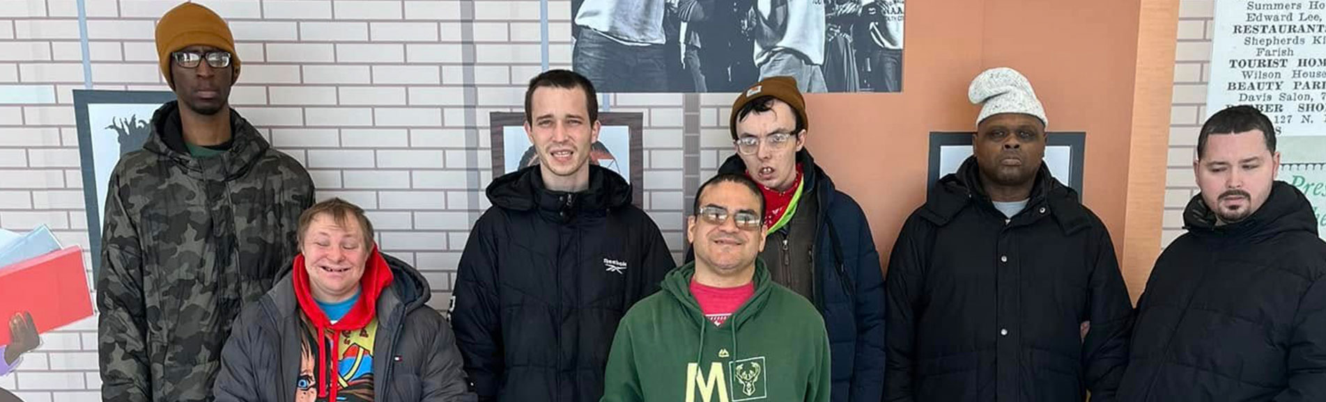 Group of residents smiling in the common area.