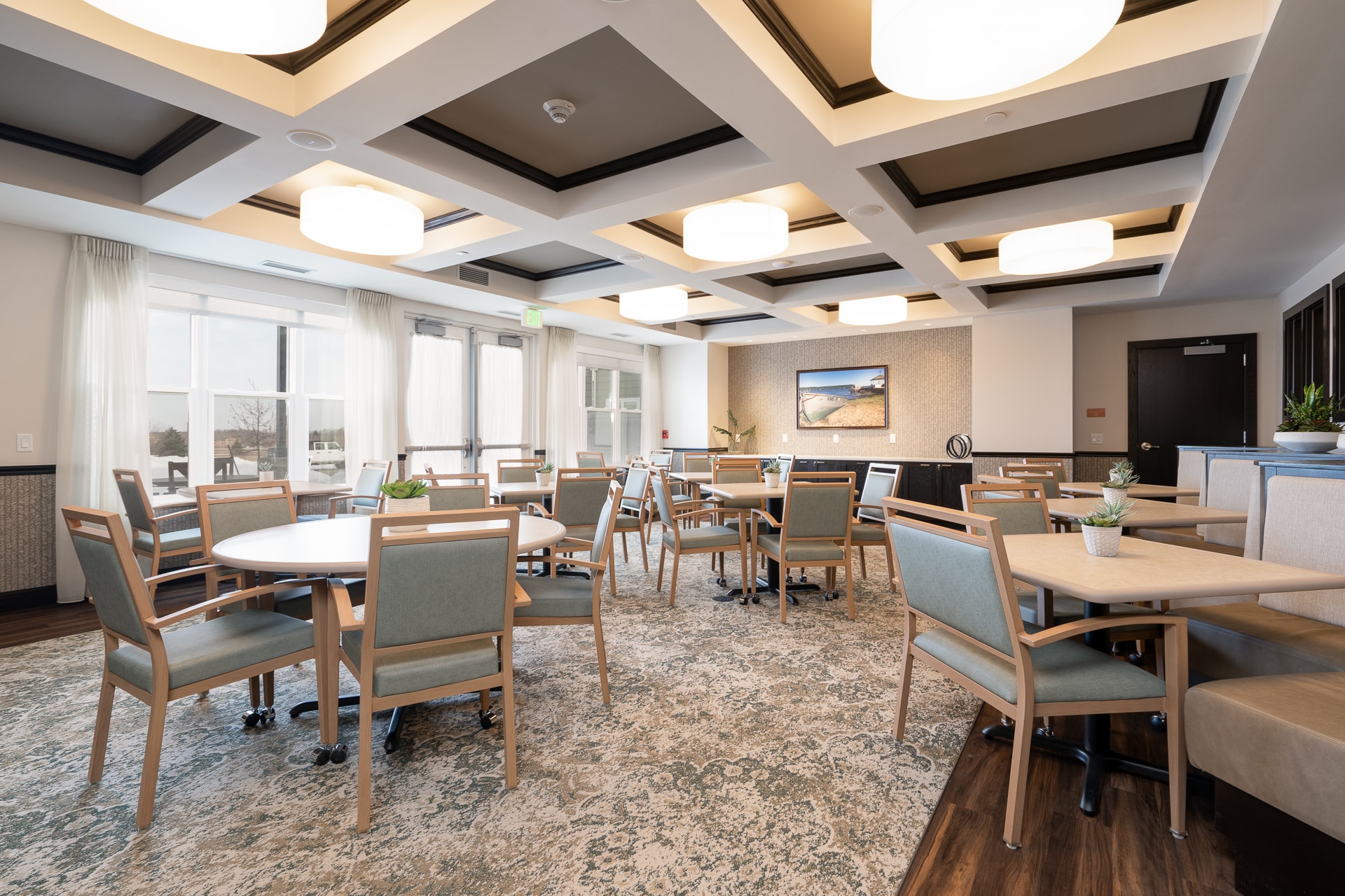 Dining area with tables and chairs in modern decor.