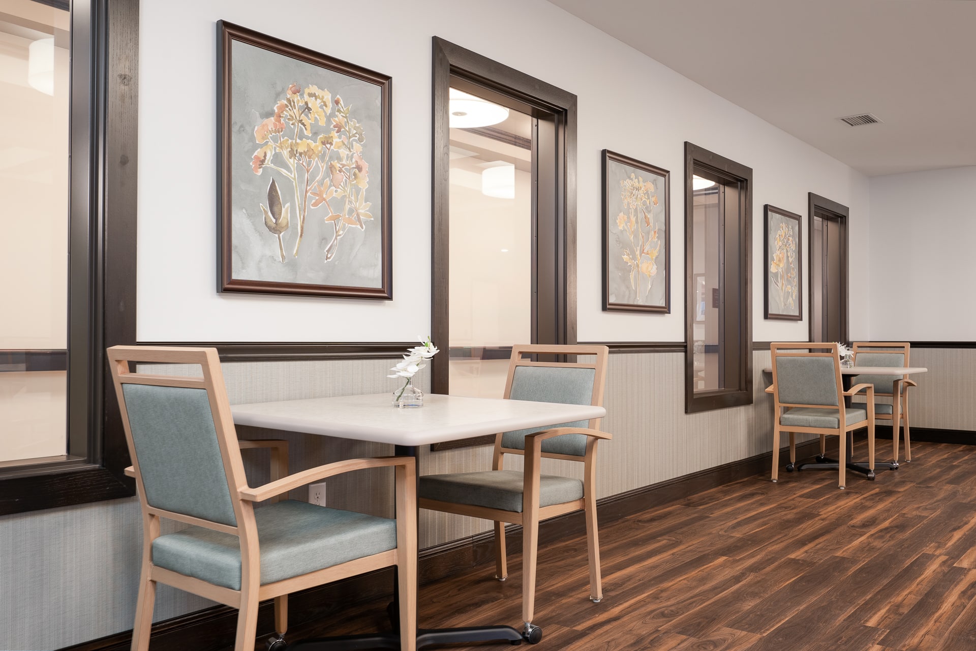 Interior common area with tables and artwork.