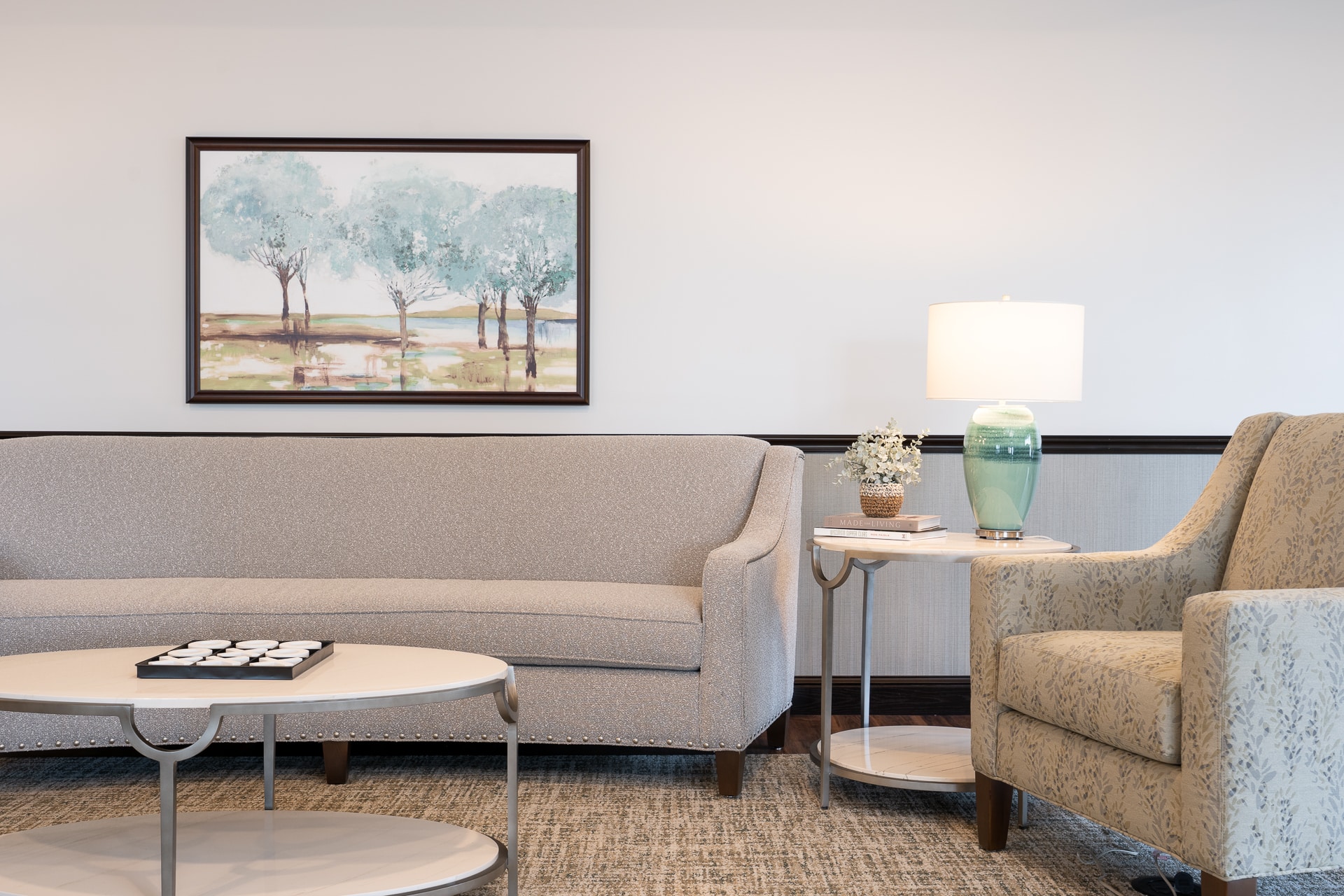 Cozy common area with a sofa and lamp.