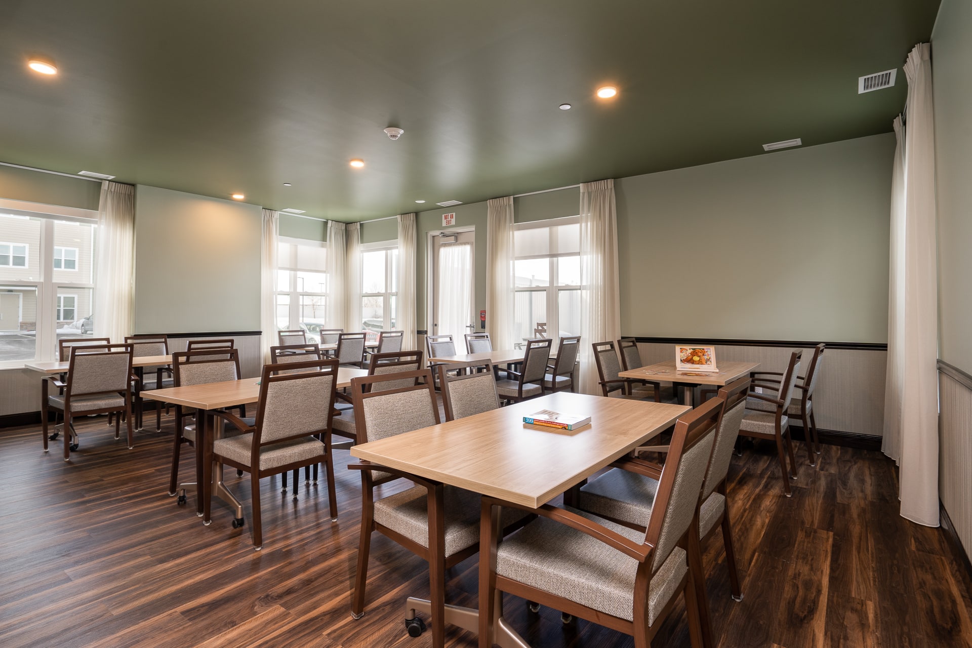 Interior view of a dining area with tables and chairs.