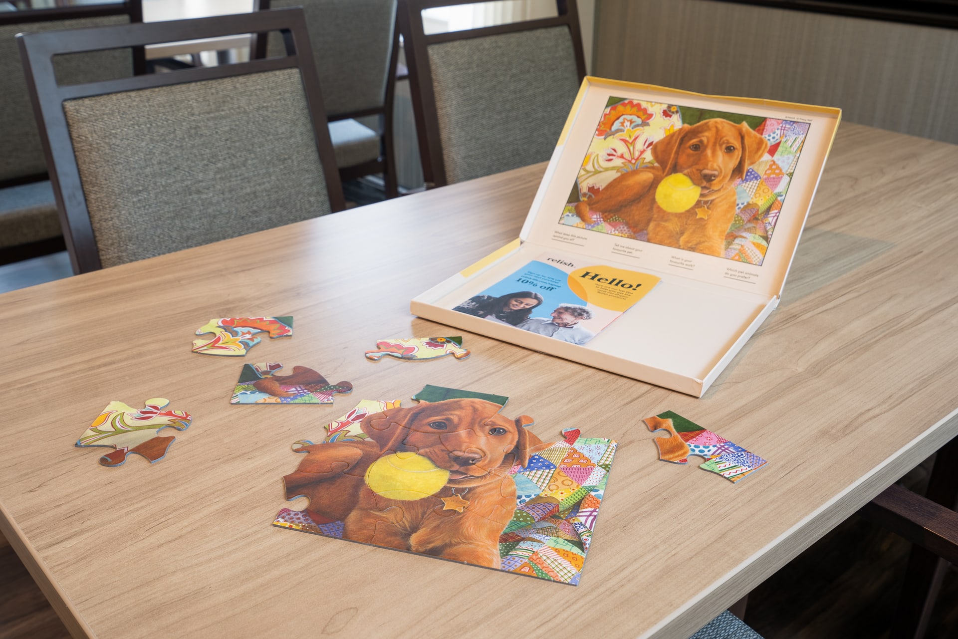 Puzzle with a dog image and activity book on a table.