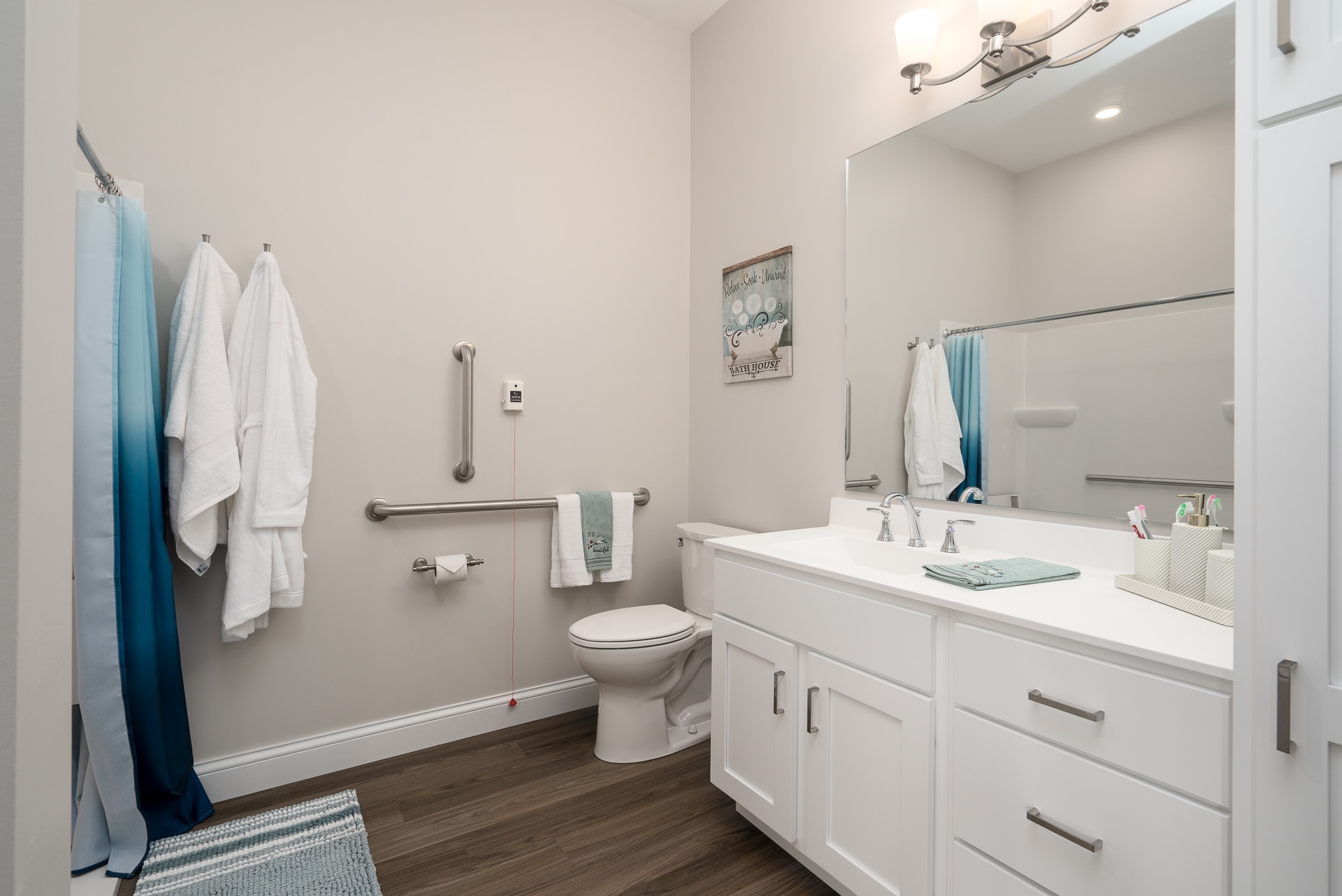 Modern bathroom with white cabinetry and towels