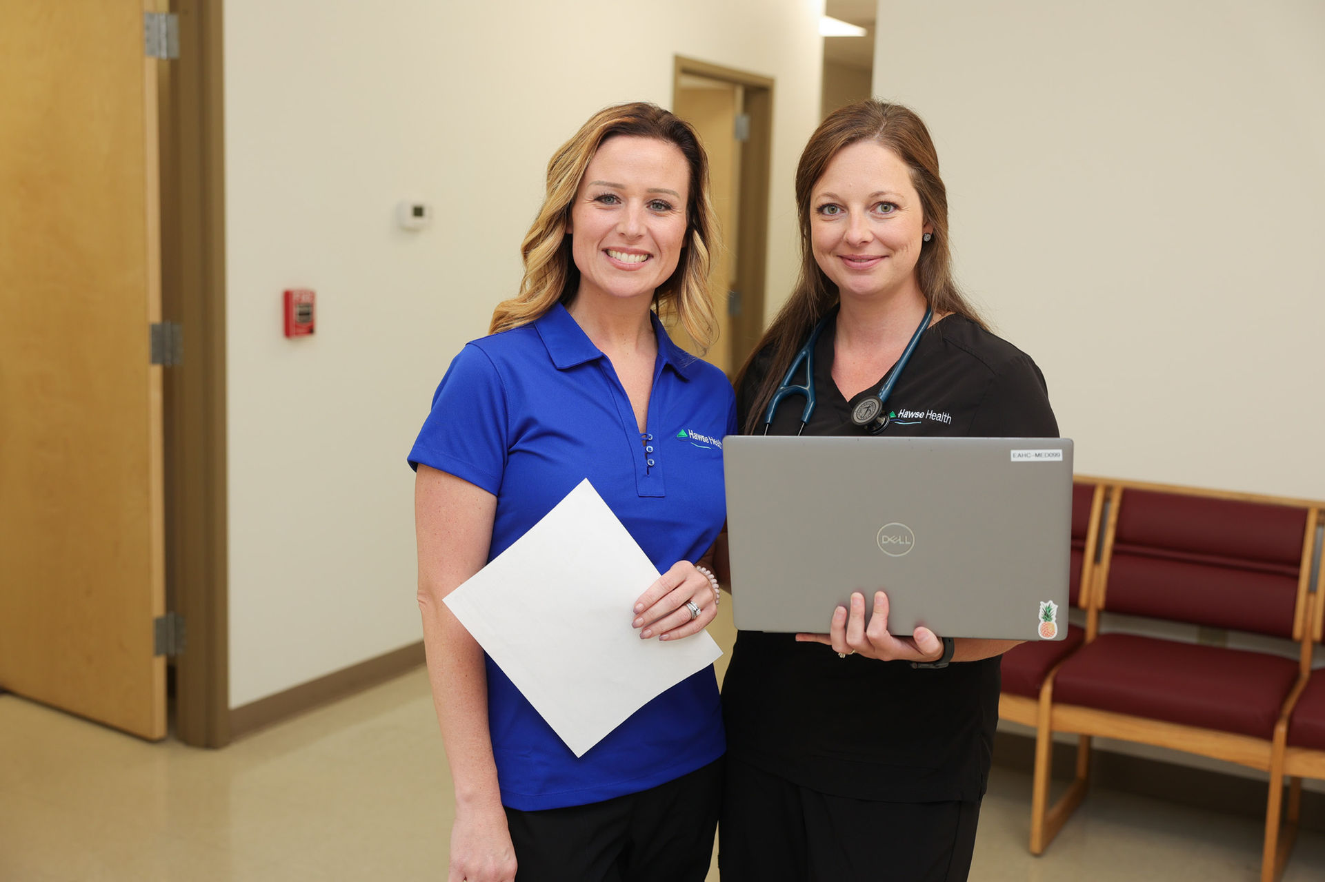 Two healthcare professionals smiling together