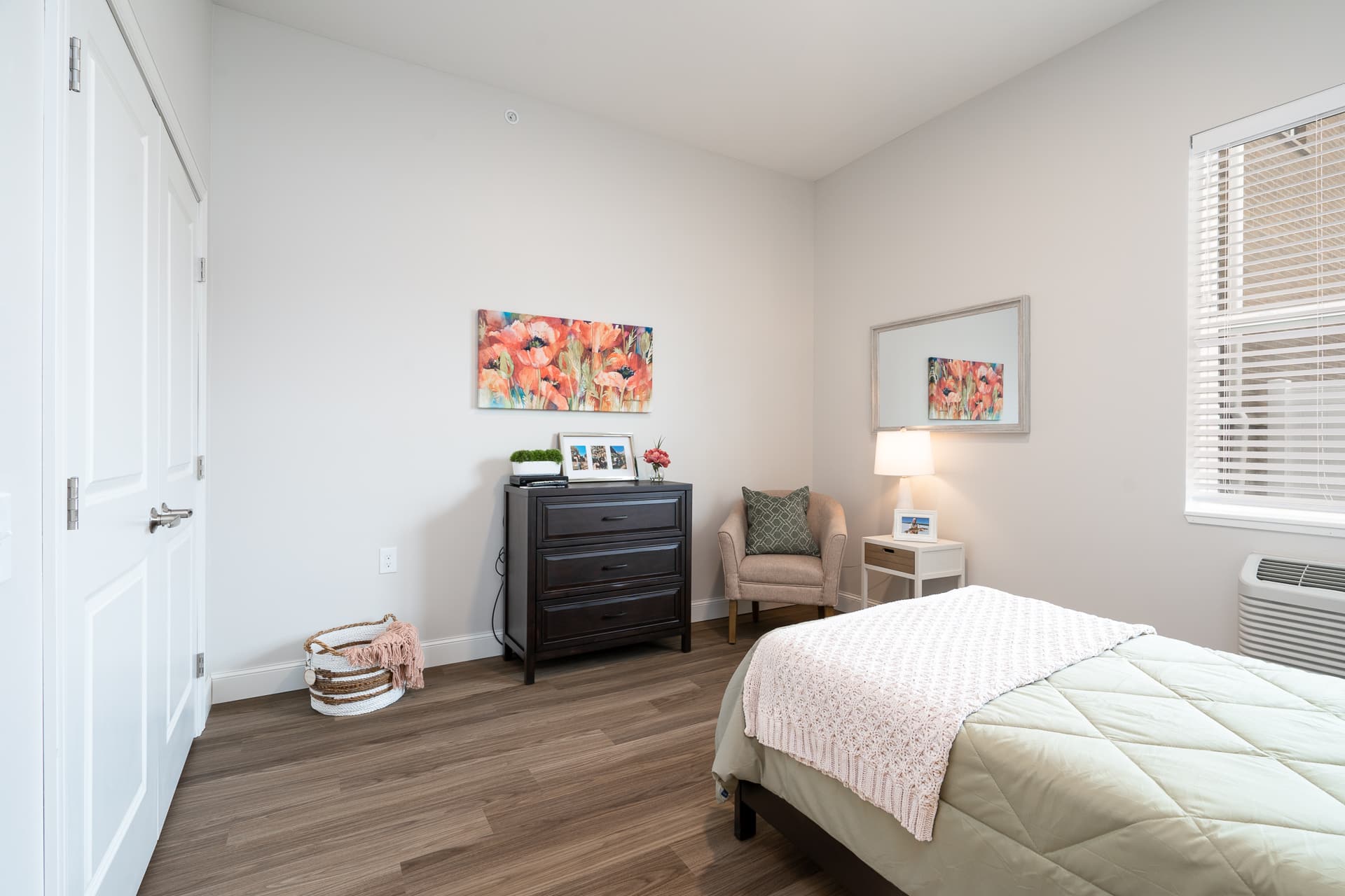 Cozy private resident room with a bed and chair