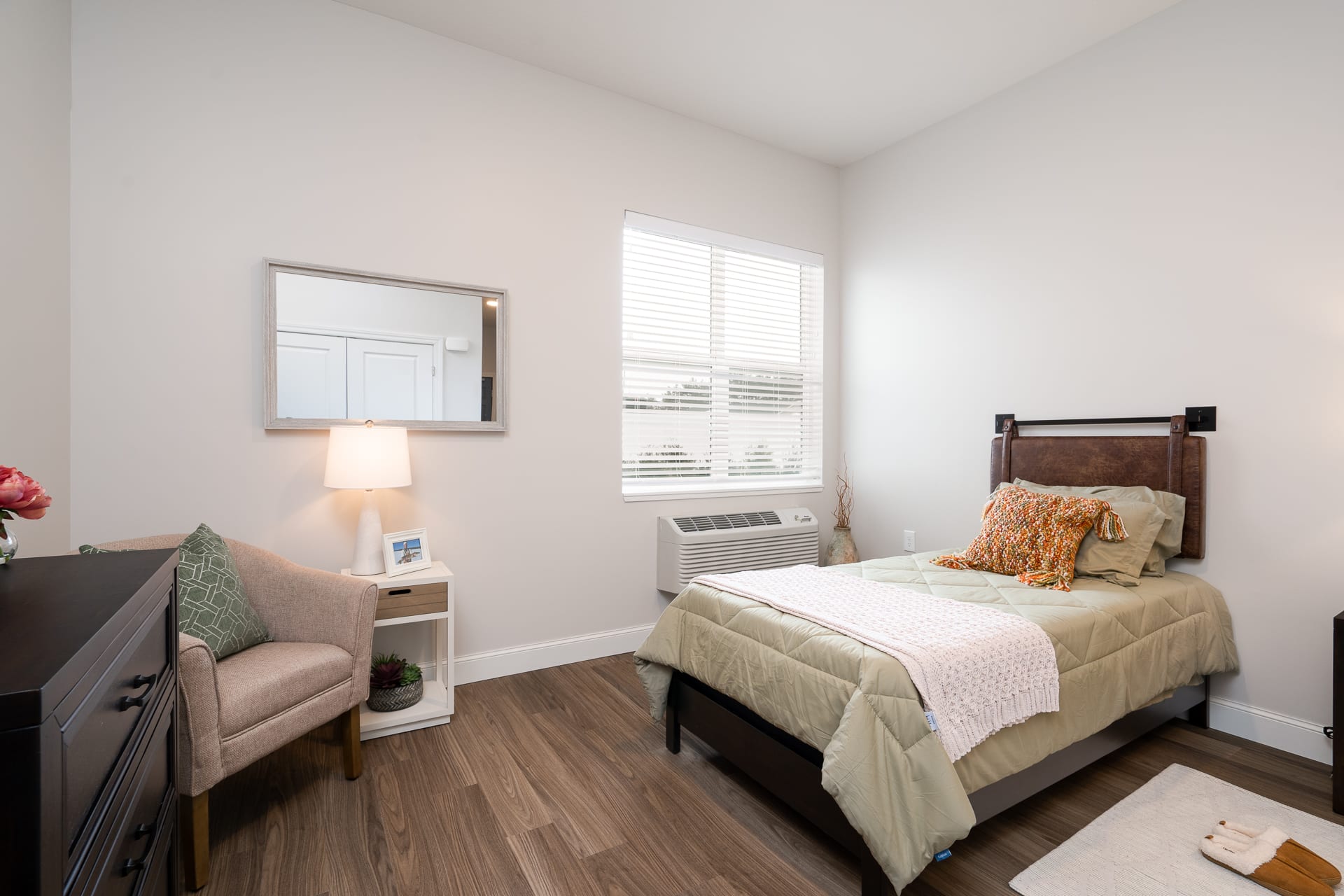 Cozy private room with a bed and chair