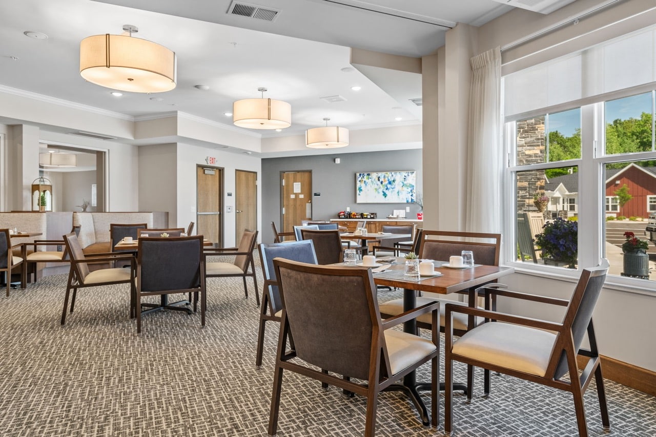 Dining area with tables and chairs for residents.
