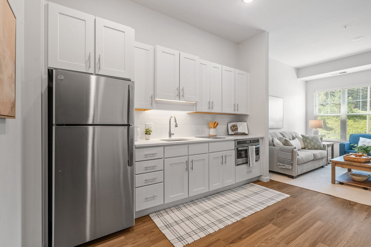 Modern kitchen area with living space in background