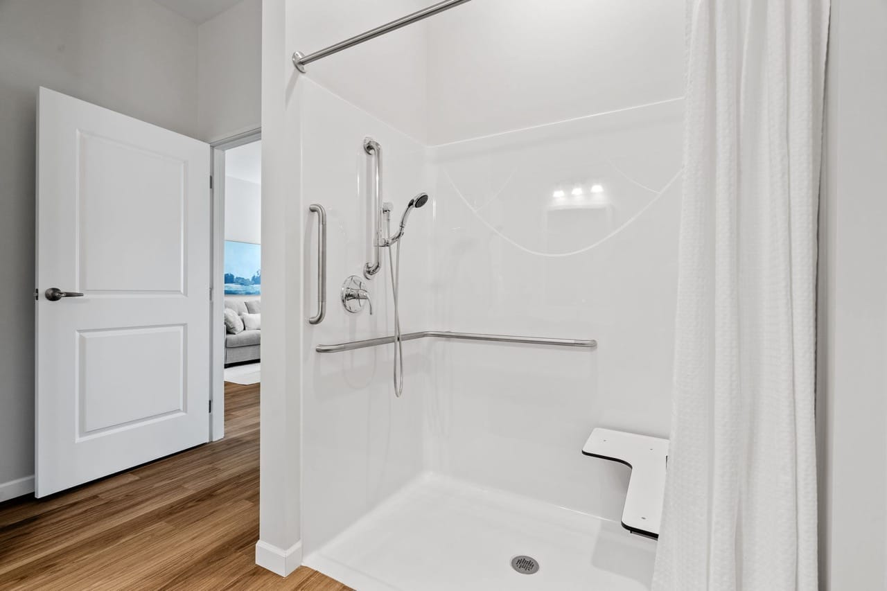 Accessible shower with grab bars in a modern bathroom
