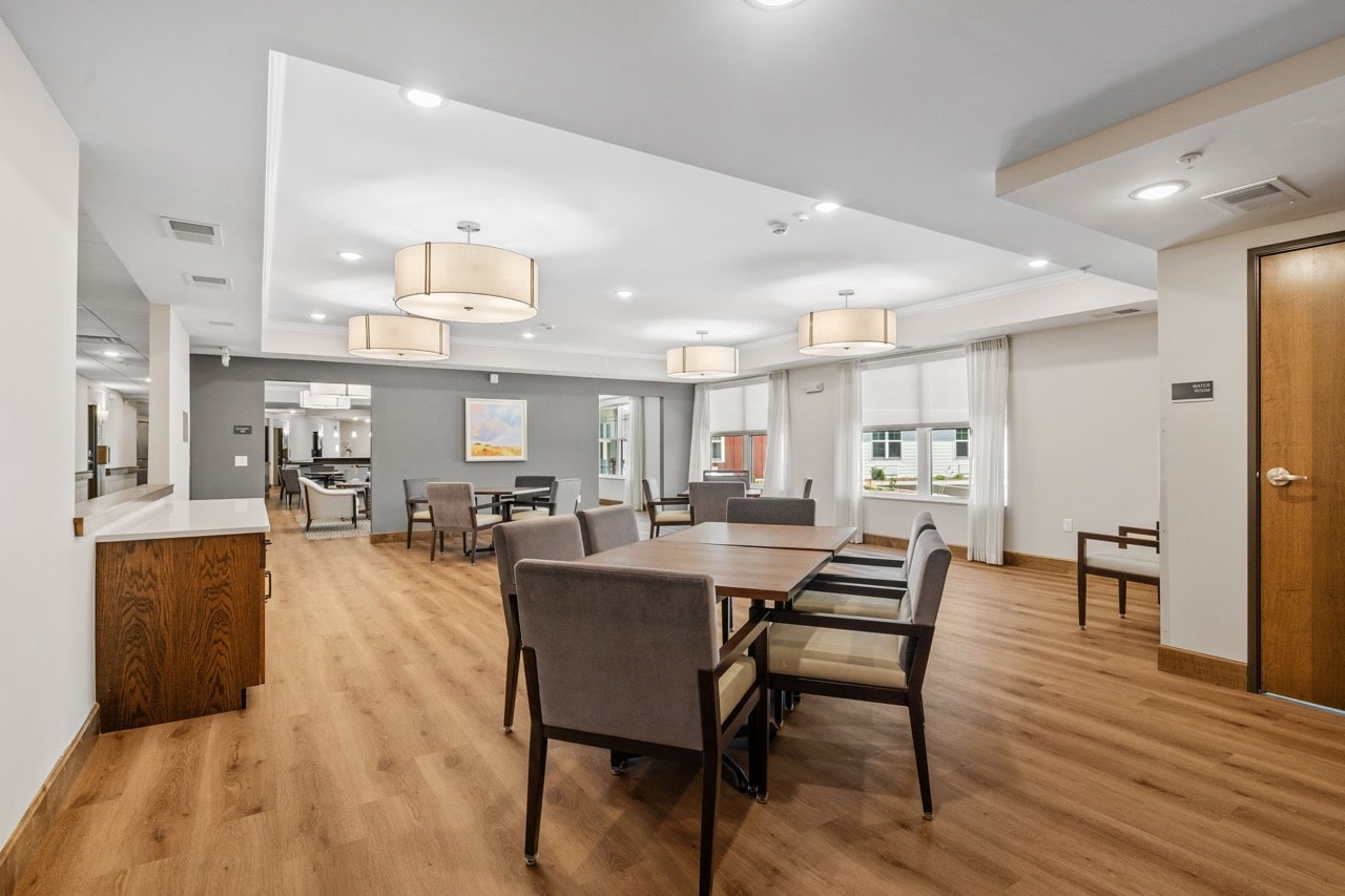 Bright common area with tables and chairs.