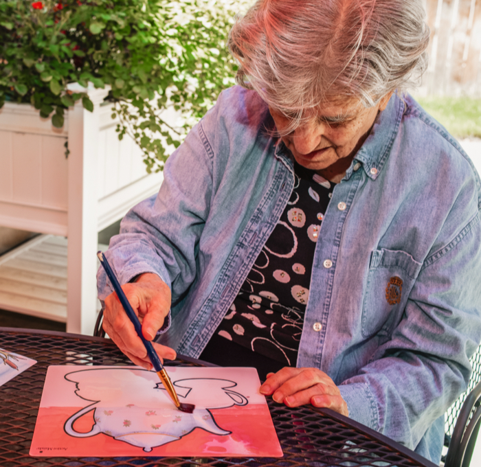 Senior woman painting outdoors