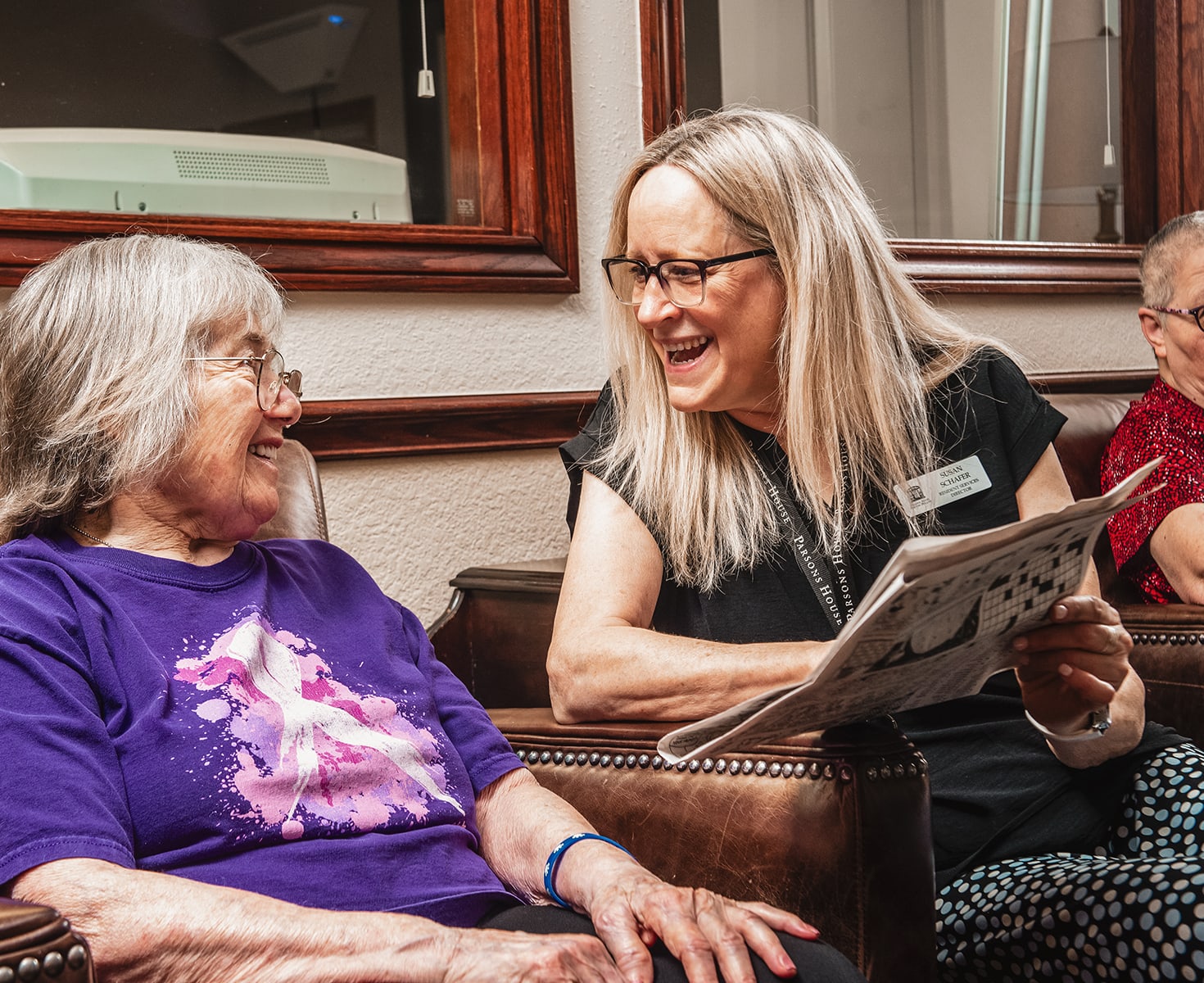 Staff member engaging with a resident in a common area.