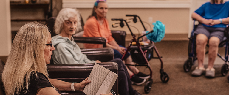 Residents engaged in a reading activity.