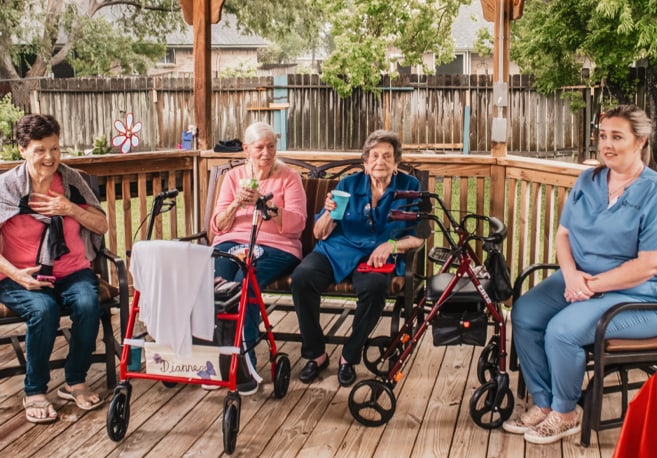 Residents enjoying time outside on a porch.