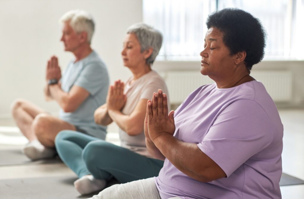 Residents participating in a yoga class indoors.