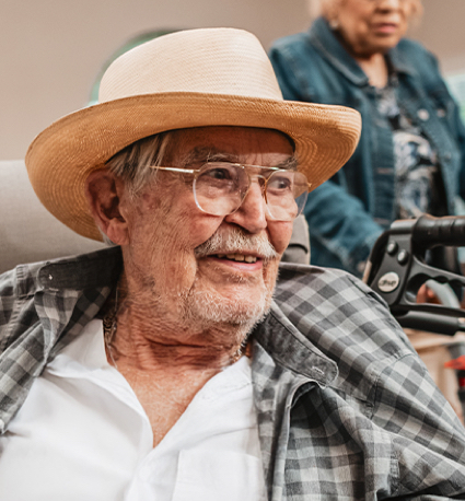 Senior man smiling in a common area.