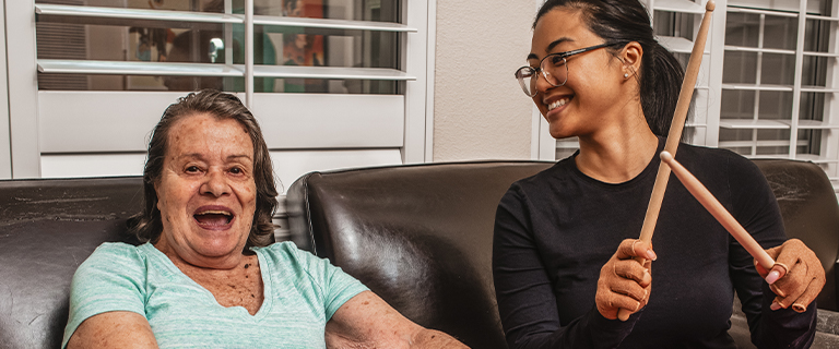 Resident engaging in music activity with staff