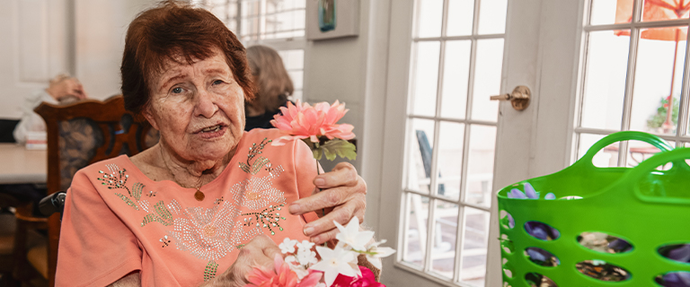 Resident engaging in a craft activity indoors.