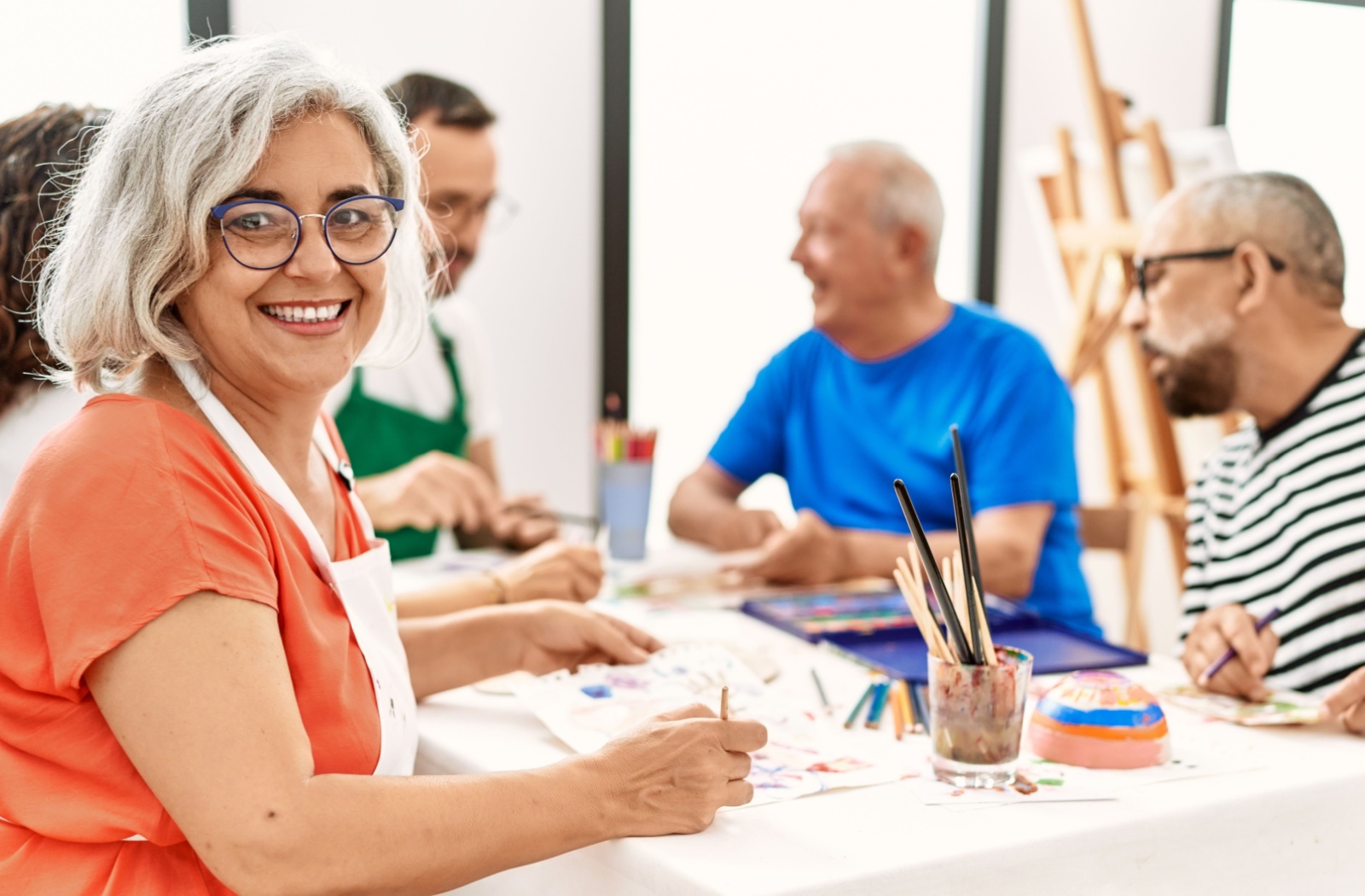 Seniors engaged in a painting activity