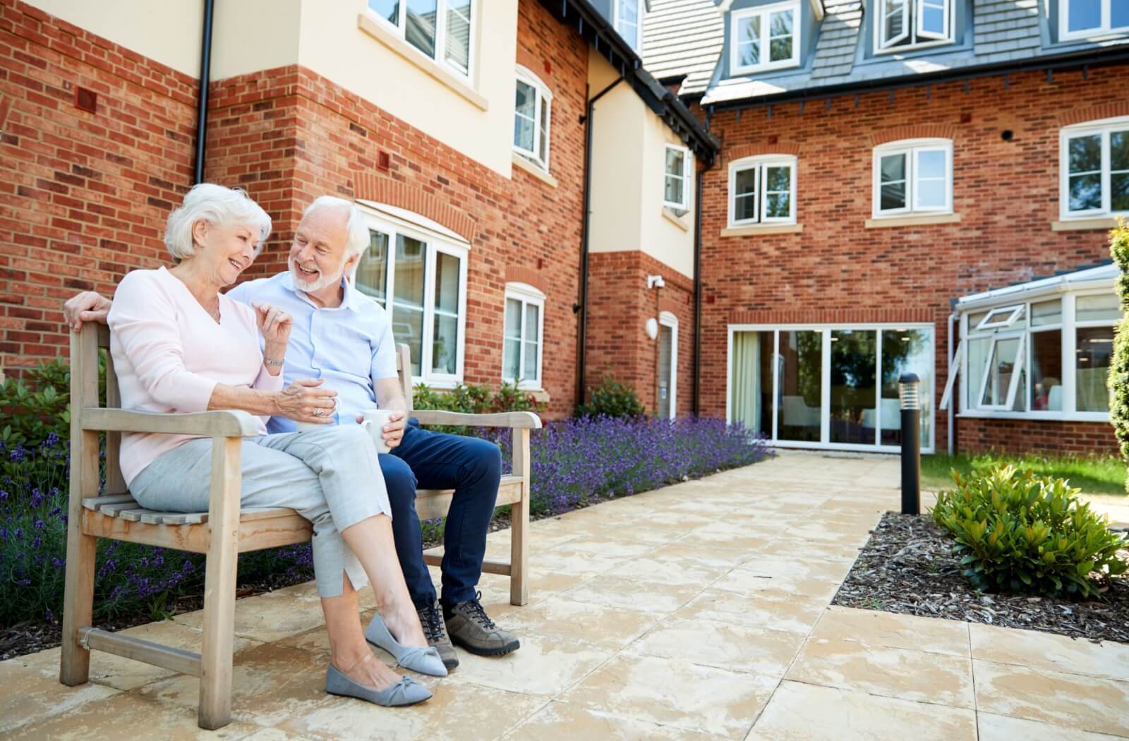 Senior couple enjoying time outside in a garden area.