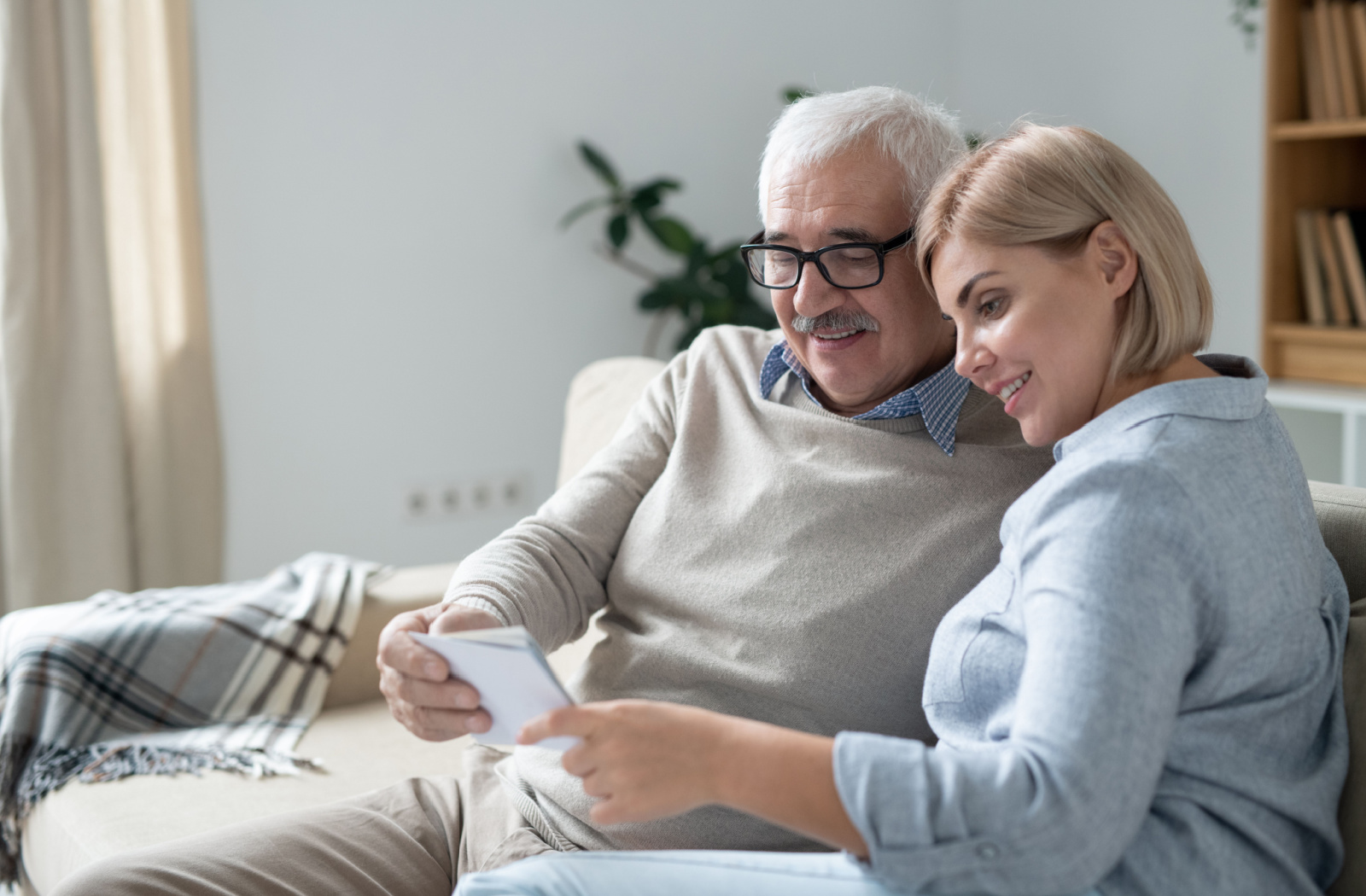 A senior man and woman reviewing photos together.